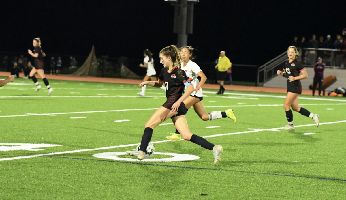 Senior captain Jackie Rainville dribbles the ball upfield. Rainville has been on varsity since her freshman year and is now committed to Williams College.